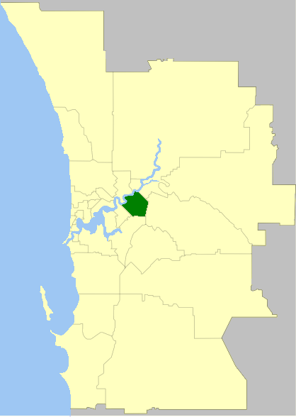 A map highlighting a specific region in dark green within a larger yellow area, with a coastal boundary on the left side.