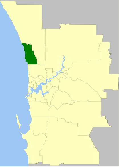 A map showing sections of land, with one section highlighted in dark green near a body of water on the left.
