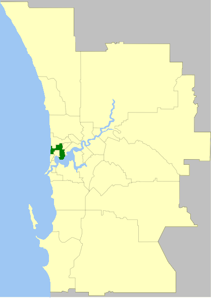 Map showing a highlighted section within a larger geographic area, indicating a specific locale or district in green. The area includes a water body on the left side.