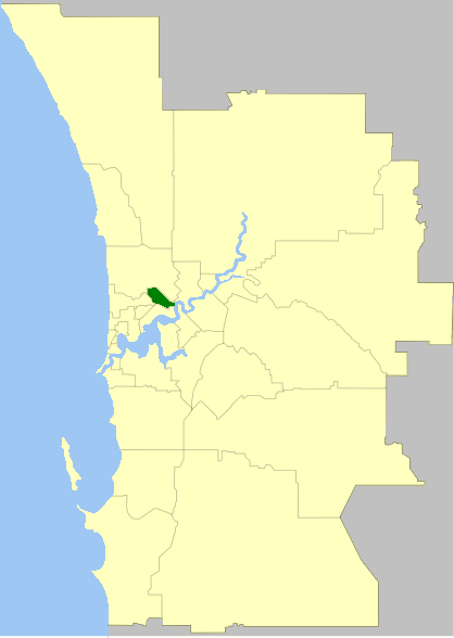 Map highlighting a small green area within a larger beige region, showing part of a coastline and an interior river system.